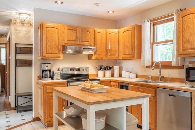 92 Wallace Ave, Auburn, MA 01501 - kitchen featuring appliances with stainless steel finishes, under cabinet range hood, wood counters, open shelves, and a center island