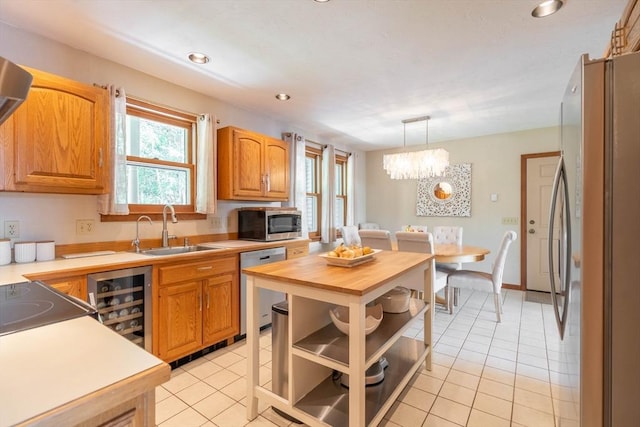 92 Wallace Ave, Auburn, MA 01501 - kitchen with appliances with stainless steel finishes, beverage cooler, light tile patterned floors, butcher block countertops, and recessed lighting