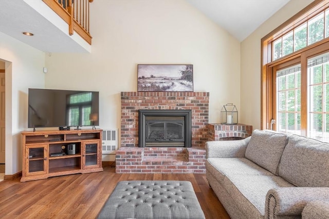 92 Wallace Ave, Auburn, MA 01501 - living room with wood finished floors, a brick fireplace, and high vaulted ceiling