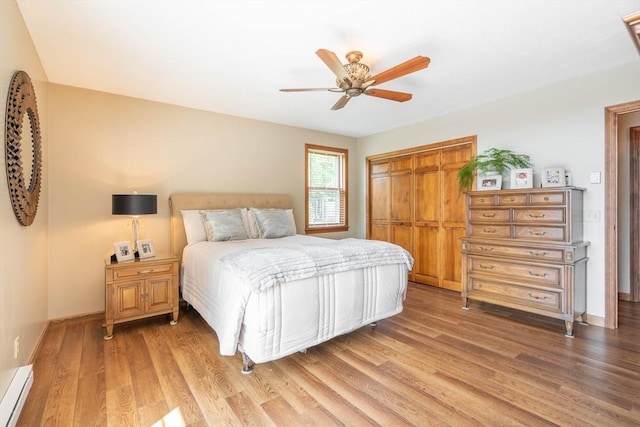 92 Wallace Ave, Auburn, MA 01501 - bedroom featuring light wood-style floors, a baseboard radiator, a closet, and a ceiling fan