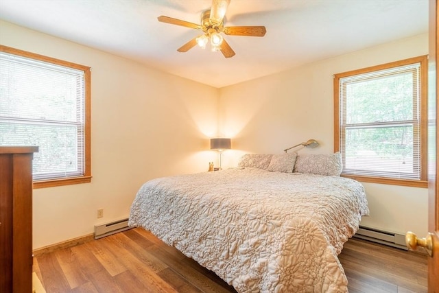 92 Wallace Ave, Auburn, MA 01501 - bedroom with a baseboard heating unit, a baseboard radiator, multiple windows, and wood finished floors