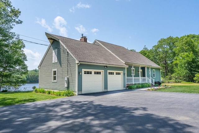 92 Wallace Ave, Auburn, MA 01501 - view of front of property featuring an attached garage, a chimney, driveway, roof with shingles, and a front yard