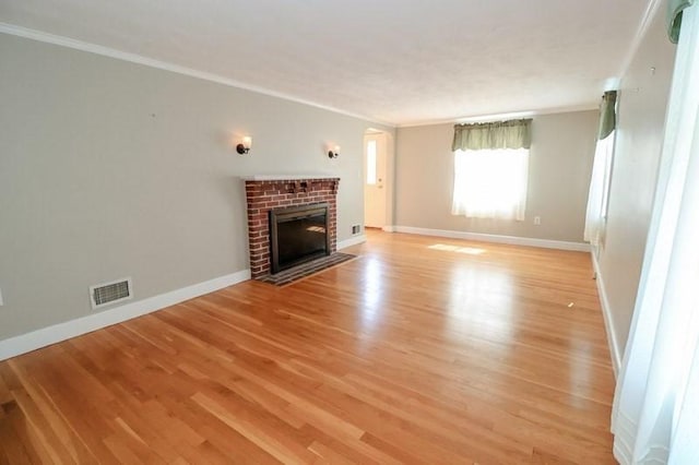 53 Perkins St, Stoneham, MA 02180 - unfurnished living room featuring ornamental molding, light wood finished floors, and a fireplace