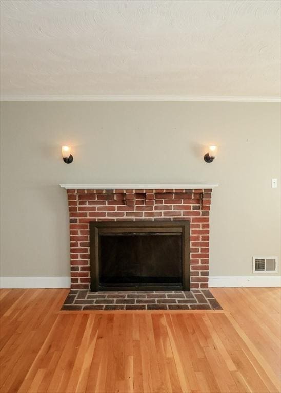 53 Perkins St, Stoneham, MA 02180 - detailed view of a fireplace, wood finished floors, and ornamental molding