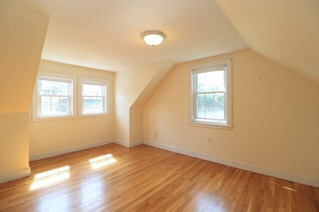 53 Perkins St, Stoneham, MA 02180 - additional living space with healthy amount of natural light, wood finished floors, and lofted ceiling