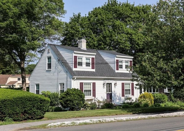 53 Perkins St, Stoneham, MA 02180 - view of front of house featuring a chimney, a shingled roof, and a front lawn