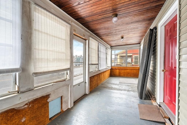 unfurnished sunroom featuring wood ceiling