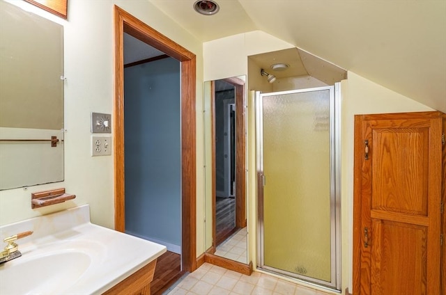 full bathroom with lofted ceiling, a stall shower, vanity, and tile patterned floors