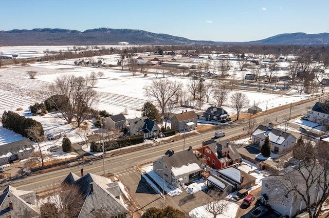 snowy aerial view with a residential view and a mountain view