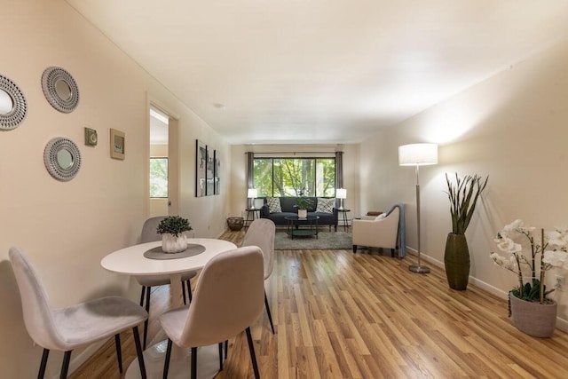dining room with baseboards and light wood finished floors