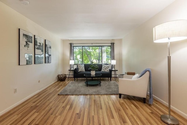 living area with baseboards and light wood-style flooring