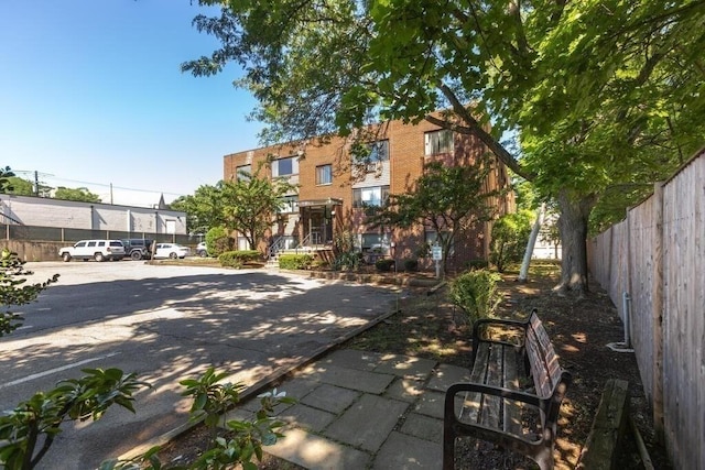 exterior space with fence and brick siding
