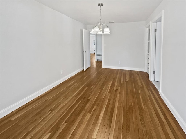 58 Morse Ave, Brockton, MA 02301 - unfurnished dining area featuring wood finished floors, baseboards, radiator heating unit, and a chandelier