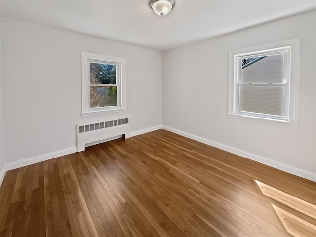 58 Morse Ave, Brockton, MA 02301 - unfurnished room with baseboards, radiator heating unit, a wealth of natural light, and hardwood / wood-style flooring