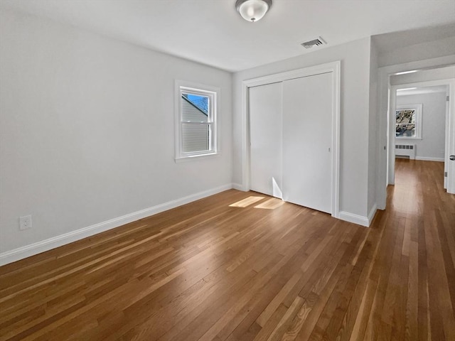 58 Morse Ave, Brockton, MA 02301 - unfurnished bedroom featuring visible vents, wood finished floors, baseboards, a closet, and radiator