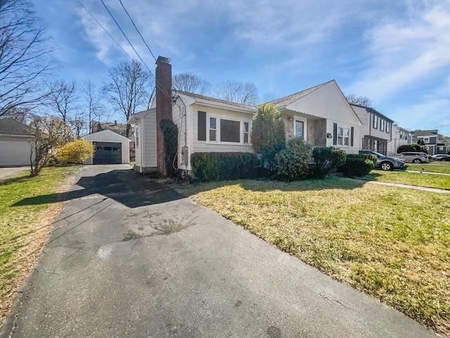 58 Morse Ave, Brockton, MA 02301 - view of front of property featuring aphalt driveway, a chimney, an outbuilding, a garage, and a front lawn