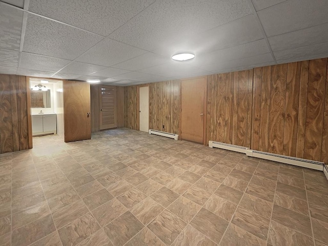 58 Morse Ave, Brockton, MA 02301 - finished below grade area featuring a paneled ceiling, a baseboard heating unit, and wooden walls