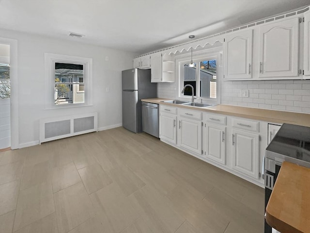 58 Morse Ave, Brockton, MA 02301 - kitchen with appliances with stainless steel finishes, a sink, visible vents, and tasteful backsplash