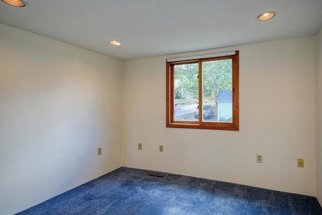 carpeted spare room with visible vents and recessed lighting