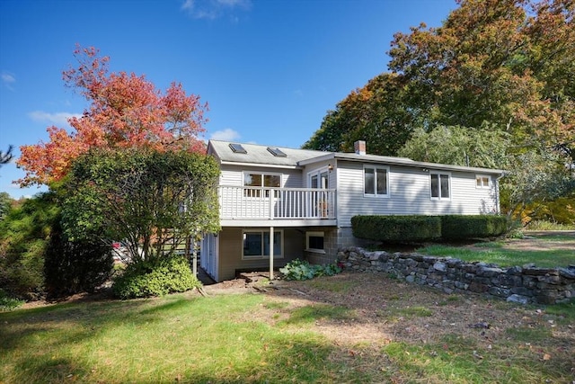 back of house with a yard and a deck