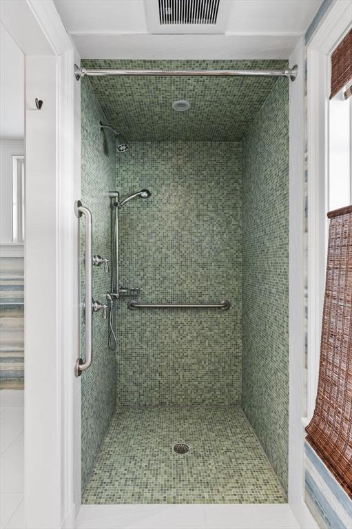 full bath with visible vents and a shower stall