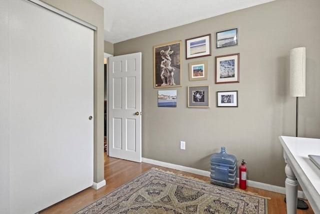 interior space featuring baseboards and wood finished floors