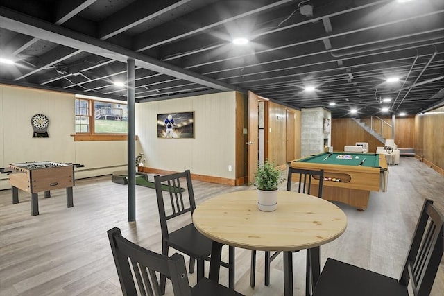 game room with a baseboard heating unit, light wood-type flooring, wood walls, and billiards