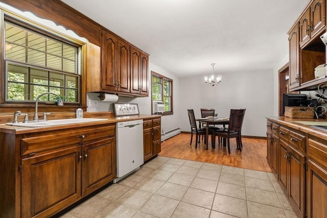 5 Villa Ln, Peabody, MA 01960 - kitchen with dishwasher, a baseboard radiator, a chandelier, light countertops, and light wood-type flooring