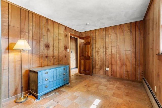 5 Villa Ln, Peabody, MA 01960 - unfurnished bedroom featuring baseboard heating, wood walls, and light floors