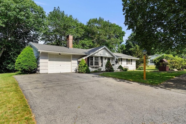 5 Villa Ln, Peabody, MA 01960 - ranch-style home featuring an attached garage, asphalt driveway, a chimney, and a front lawn