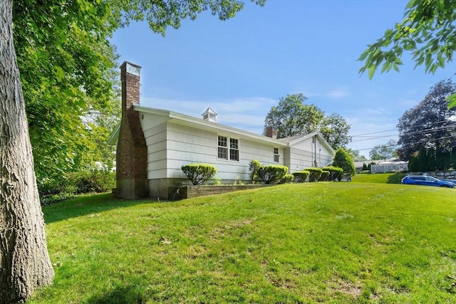 5 Villa Ln, Peabody, MA 01960 - view of home's exterior featuring a chimney and a yard