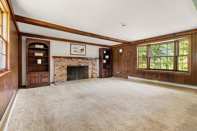 5 Villa Ln, Peabody, MA 01960 - unfurnished living room featuring a baseboard heating unit, wooden walls, beam ceiling, a brick fireplace, and carpet floors