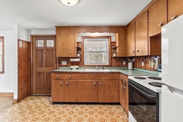 kitchen with freestanding refrigerator, a healthy amount of sunlight, open shelves, a sink, and range with electric stovetop