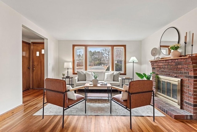 living area featuring a fireplace and wood finished floors