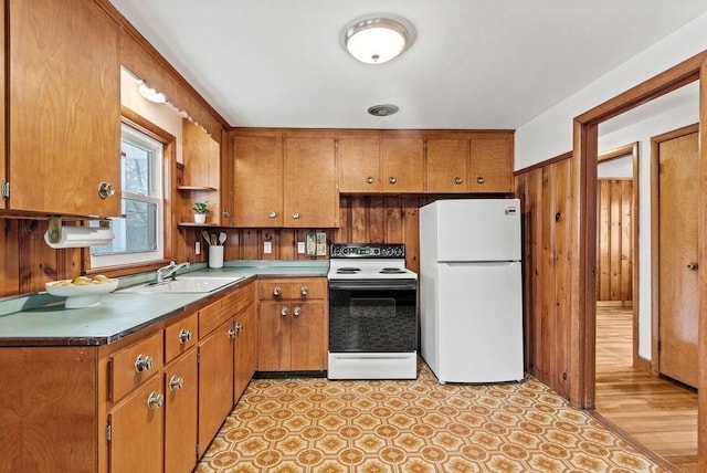 kitchen with open shelves, white appliances, a sink, and brown cabinets