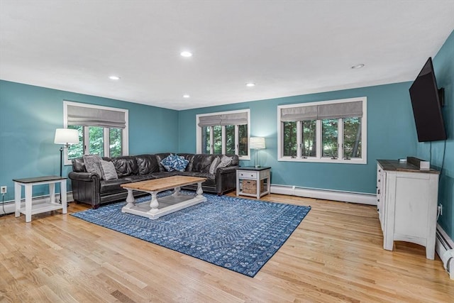 16 Vanderbelt Rd, Acton, MA 01720 - living area with a baseboard heating unit, wood finished floors, recessed lighting, and baseboards