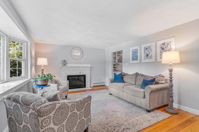 16 Vanderbelt Rd, Acton, MA 01720 - living room with a baseboard radiator, wood finished floors, baseboards, and a fireplace