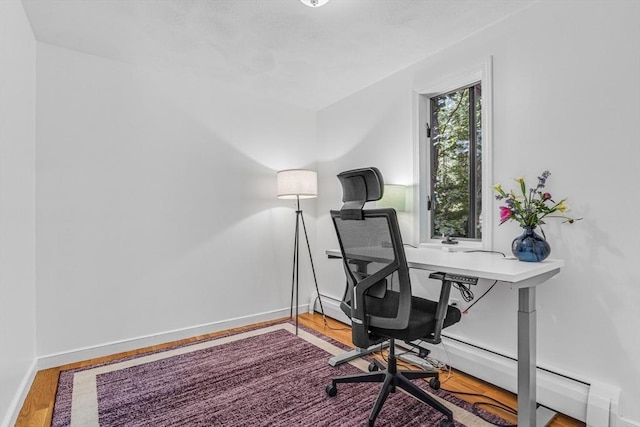 16 Vanderbelt Rd, Acton, MA 01720 - office with wood finished floors, baseboards, and a baseboard radiator