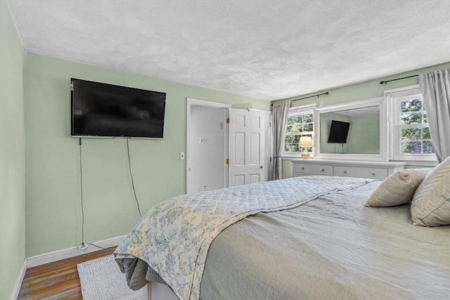 16 Vanderbelt Rd, Acton, MA 01720 - bedroom featuring a textured ceiling, baseboards, and dark wood finished floors