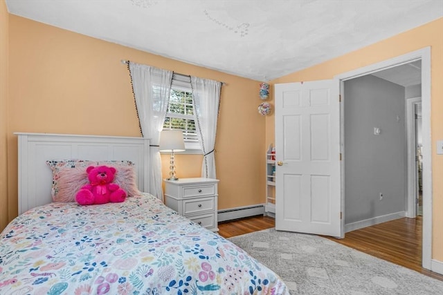 16 Vanderbelt Rd, Acton, MA 01720 - bedroom with baseboard heating, wood finished floors, and baseboards
