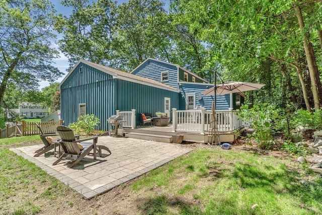 16 Vanderbelt Rd, Acton, MA 01720 - rear view of house featuring board and batten siding, a wooden deck, and a patio area