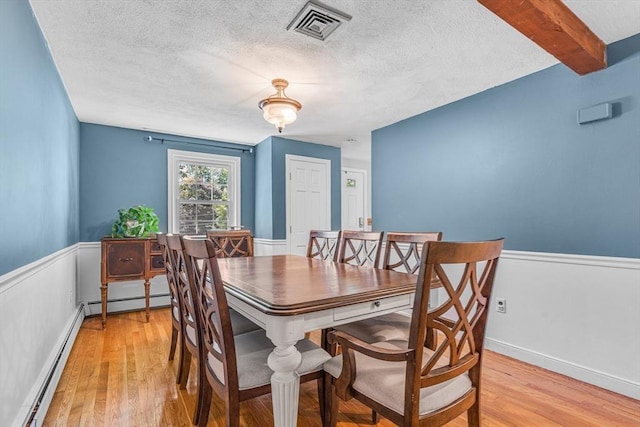 16 Vanderbelt Rd, Acton, MA 01720 - dining room featuring a textured ceiling, light wood-type flooring, and a baseboard heating unit