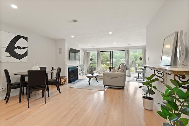 116 Mill Pond Unit 116, North Andover, MA 01845 - living room with a fireplace with flush hearth, light wood finished floors, and recessed lighting