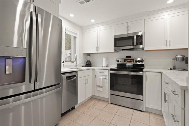 116 Mill Pond Unit 116, North Andover, MA 01845 - kitchen featuring stainless steel appliances, white cabinetry, light tile patterned floors, and recessed lighting