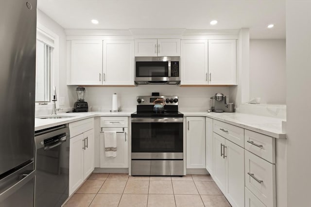 116 Mill Pond Unit 116, North Andover, MA 01845 - kitchen with appliances with stainless steel finishes, white cabinets, light countertops, light tile patterned floors, and recessed lighting