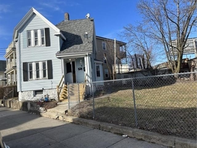 view of front of house featuring a shingled roof, fence private yard, and a chimney