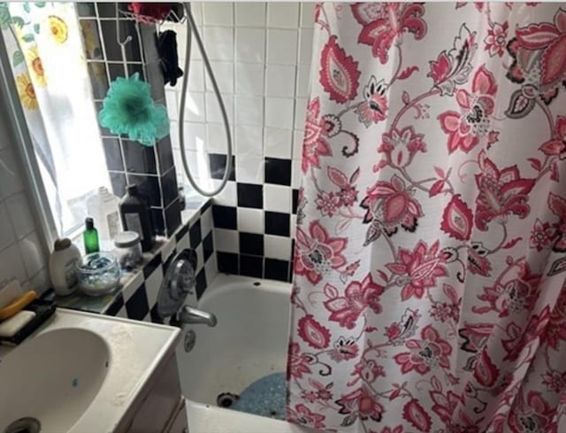 full bath featuring vanity and shower / tub combo with curtain