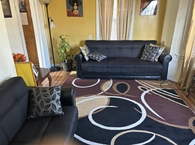 living room featuring baseboards and wood finished floors