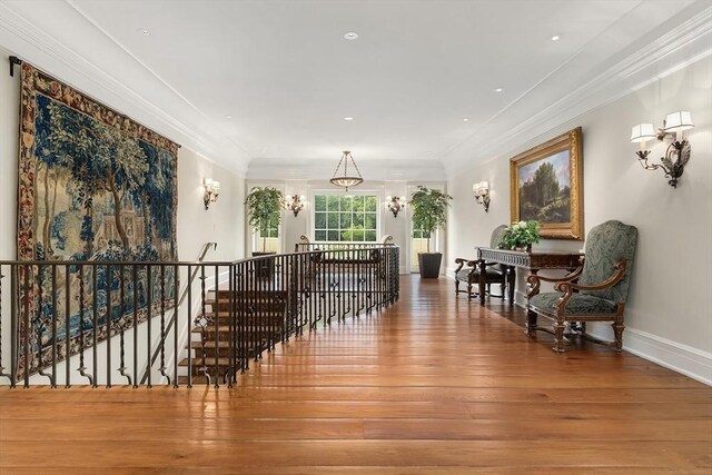 180 Ash St, Weston, MA 02493 - sitting room with an upstairs landing, hardwood / wood-style flooring, crown molding, a chandelier, and baseboards