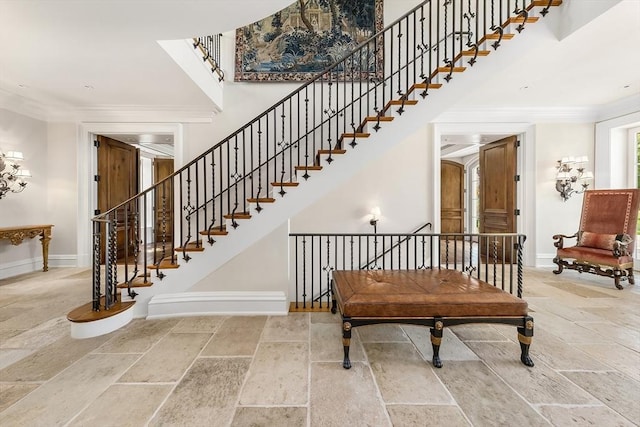 180 Ash St, Weston, MA 02493 - stairway featuring stone tile floors, baseboards, and crown molding